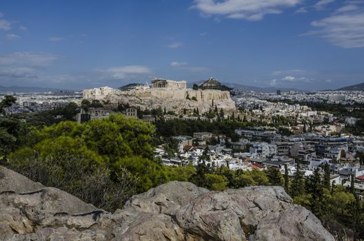 view from the philopappos hill of the acropolis and in the background the hill lycabettus