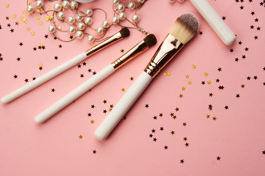 cosmetic accessories eyeshadow accessories makeup brushes merchandise collection professional cosmetics on pink background.