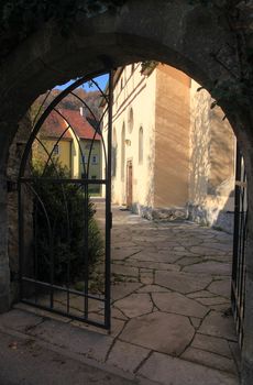 Open iron gate and footpath leading to a church