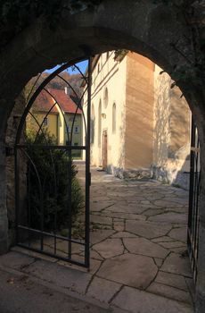 Open iron gate and footpath leading to a church