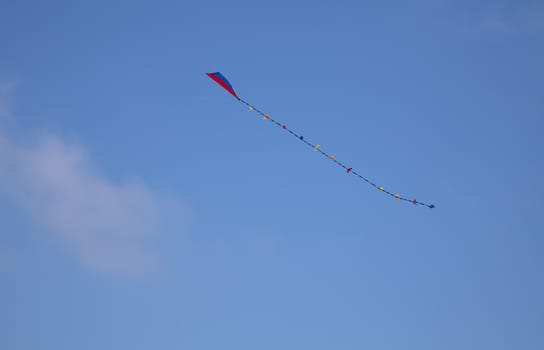 Colorful kite in the blue sky with copy space