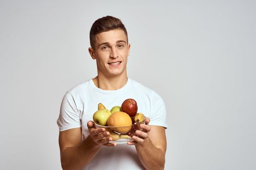 Man with fresh fruit in a cup health lifestyle healthy nutrition vitamins. High quality photo
