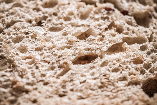 Fresh whole grain seeded bread, organic wheat flour, closeup slice texture as background for food blog or cook book recipes