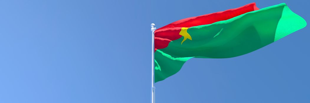 3D rendering of the national flag of Burkina Faso waving in the wind against a blue sky