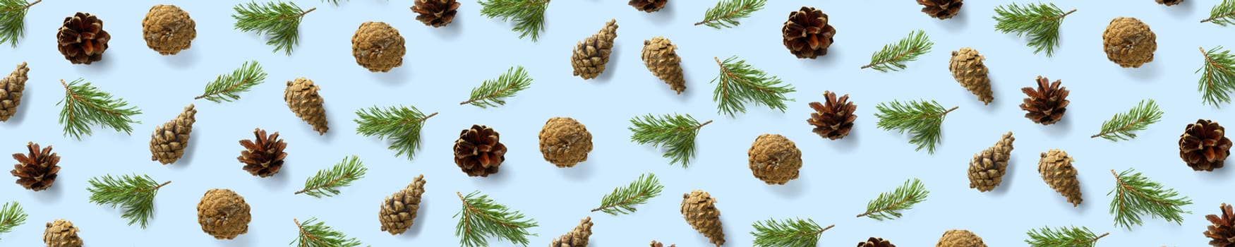 Creative Pine cone Christmas background on blue. Pine branches and cones. minimal creative cone arrangement pattern. flat lay, top view. new year background wallpaper. Nature pinecone modern christmas Background