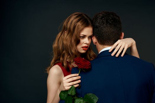 luxury couple hug romance relationship rose over dark isolated background. High quality photo