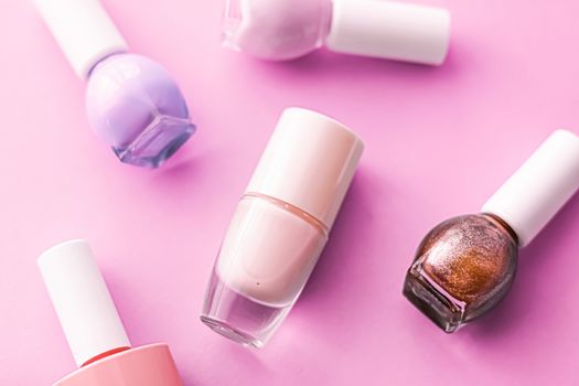 Nail polish bottles on pink background, beauty branding