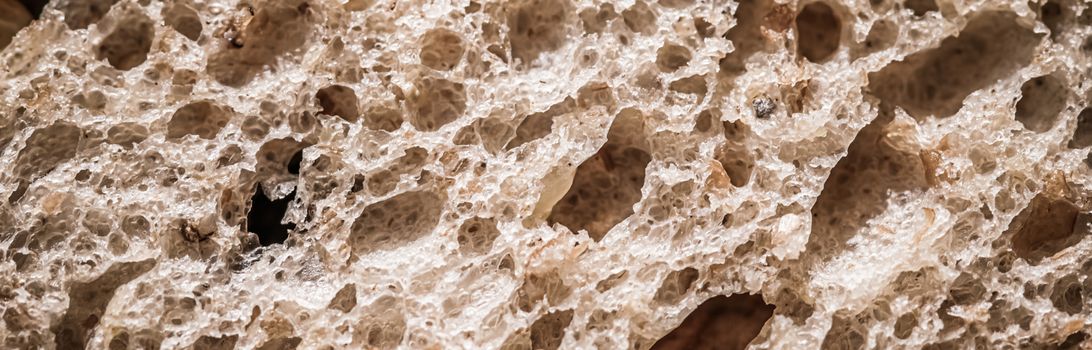 Fresh whole grain seeded bread, organic wheat flour, closeup slice texture as background for food blog or cook book recipes