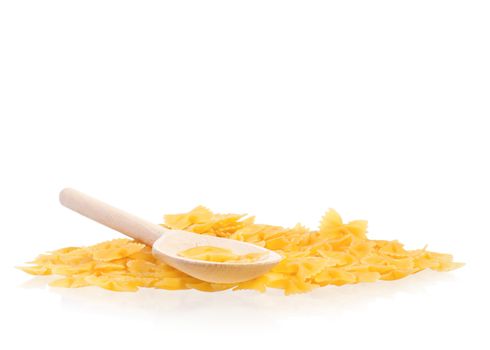 Wooden spoon with dry yellow pasta isolated on white background. Uncooked Italian raw pasta. 