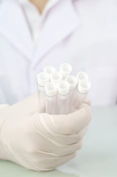 Technician scientist analyzing holding test tube in laboratory for testing it on COVID, COVID-19, coronavirus virus analysis