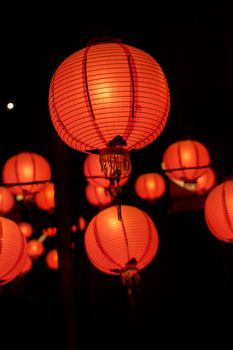 Beautiful round red lantern hanging on old traditional street, concept of Chinese lunar new year festival in Taiwan, close up. The undering word means blessing.