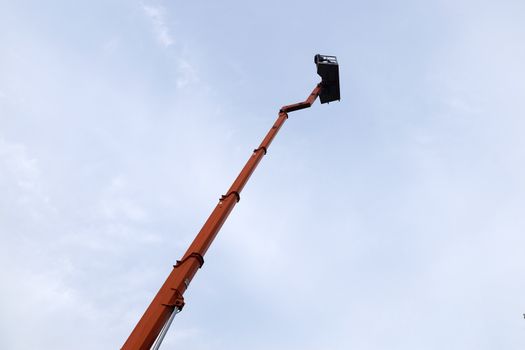retractable hydraulic fire boom with cradle against the sky.