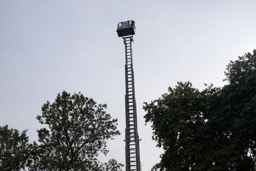 retractable fire stairs on the background of trees and sky