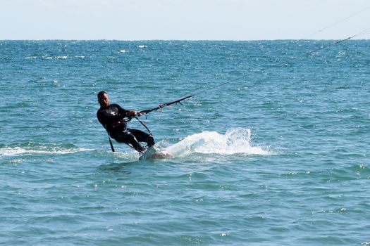 Varna, Bulgaria - September, 19, 2020: a man is kiting the sea against the background of the beachVarna
