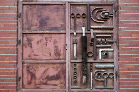 old metal brown gate decorated with forged elements close up
