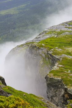 Fog, clouds, rocks and cliffs on Veslehødn Veslehorn mountain in Hemsedal, Norway.