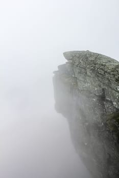 Fog, clouds, rocks and cliffs on Veslehødn Veslehorn mountain in Hemsedal, Norway.