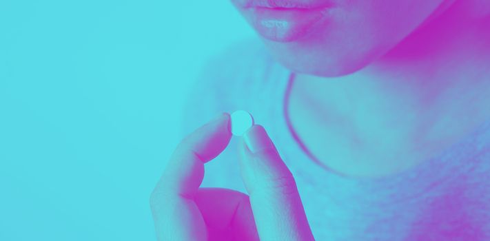 Close-up images of people taking or holding a medicine pill in hand which help and protect from pandemic virus and relief them from unhealthy and sickness. studio shot and clear background.