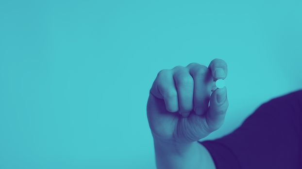 Close-up images of people taking or holding a medicine pill in hand which help and protect from pandemic virus and relief them from unhealthy and sickness. studio shot and clear background.