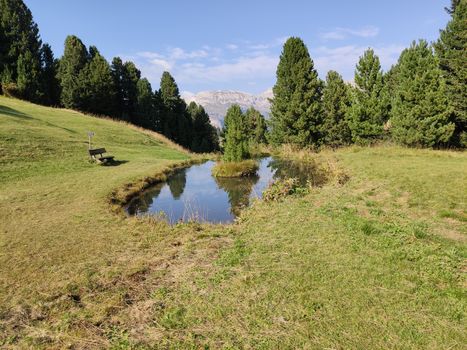 Val Gardena, Italy - 09/15/2020: Scenic alpine place with magical Dolomites mountains in background, amazing clouds and blue sky in Trentino Alto Adige region, Italy, Europe