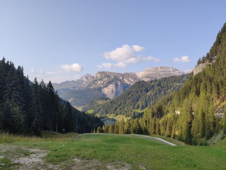 Val Gardena, Italy - 09/15/2020: Scenic alpine place with magical Dolomites mountains in background, amazing clouds and blue sky in Trentino Alto Adige region, Italy, Europe