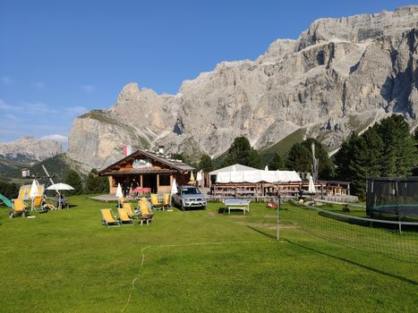 Val Gardena, Italy - 09/15/2020: Scenic alpine place with magical Dolomites mountains in background, amazing clouds and blue sky in Trentino Alto Adige region, Italy, Europe