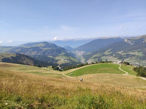 Val Gardena, Italy - 09/15/2020: Scenic alpine place with magical Dolomites mountains in background, amazing clouds and blue sky in Trentino Alto Adige region, Italy, Europe