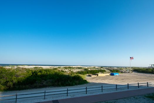 The Beach With a Wooden Fence and Sand Dunes Covered in Plants in Wildwood New Jersey