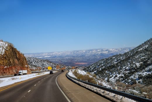 Snow capped mountains in Colorado snow covered roadway