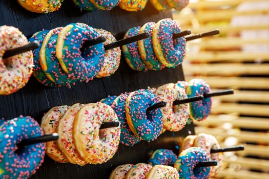 Assorted donuts on a wand. Dessert colorful snack.