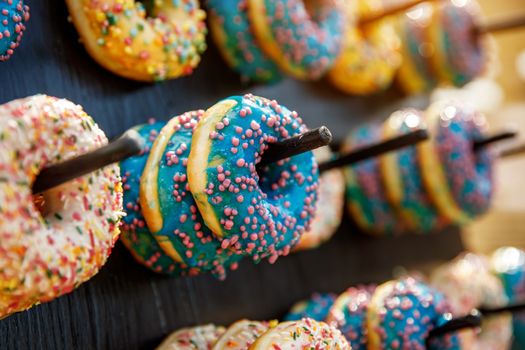 Assorted donuts on a wand. Dessert colorful snack.