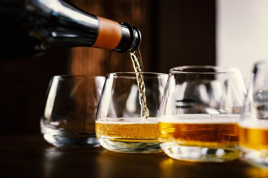 Waiter pouring wine into wineglass. Sommelier pours alcoholic drink