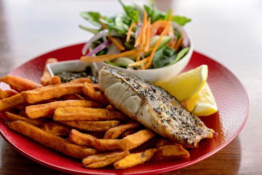 A typical Aussie pub meal of grilled fish, chips and salad served in an Australian hotel