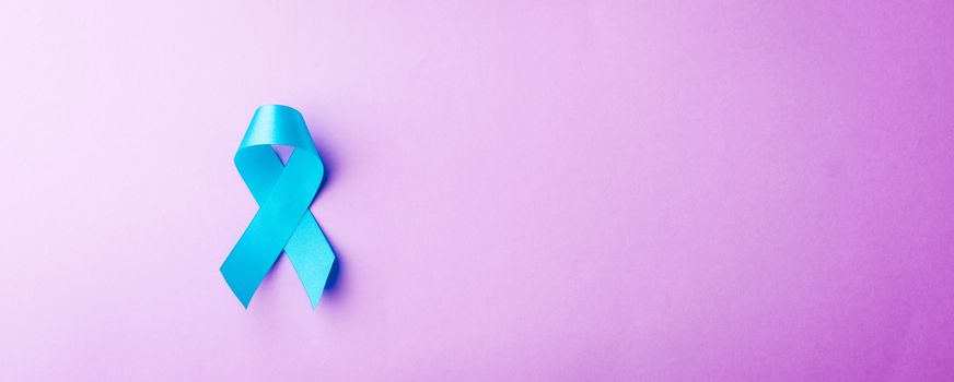 November light blue ribbon, studio shot isolated on purple background, Prostate cancer awareness month, men's health concept