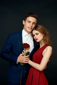 luxury couple hug romance relationship rose over dark isolated background. High quality photo