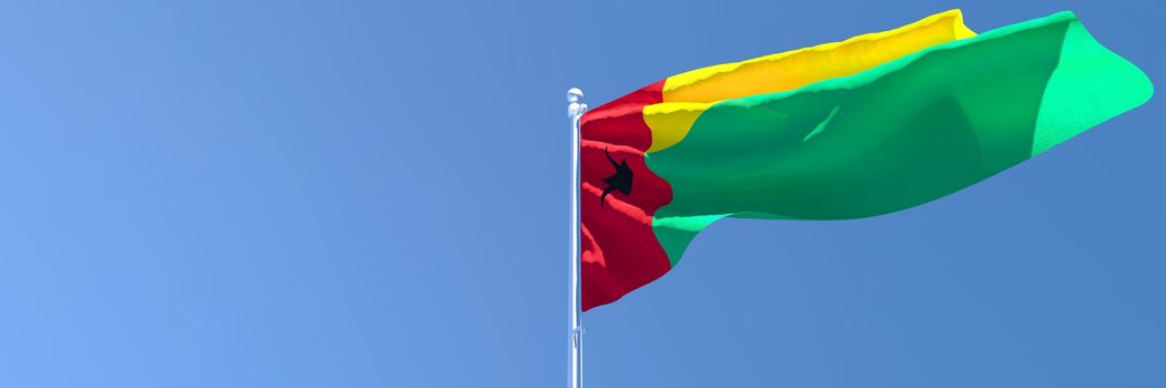 3D rendering of the national flag of Guinea Bissau waving in the wind against a blue sky