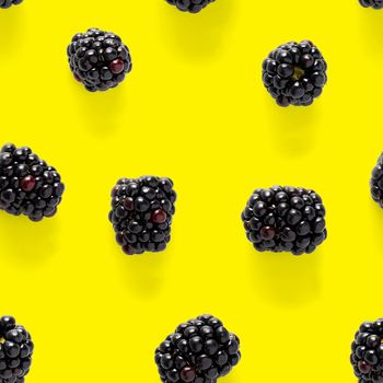 Bramble Seamless pattern. Fresh blackberry seamless pattern. Square pattern with fresh wild berries isolated on yellow background. flat lay.