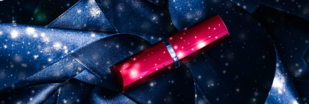 Red lipstick on blue silk and shiny glitter background, luxury make-up and beauty cosmetics