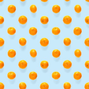 Fresh mandarin Seamles pattern. Ripe fruit tangerines seamless pattern. Fresh citrus isolated on blue background pattern. Flat lay of Clementine. Mandarine modern tropical seamless background.