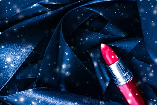 Red lipstick on blue silk and shiny glitter background, luxury make-up and beauty cosmetics