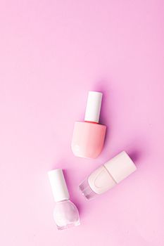 Nail polish bottles on pink background, beauty branding