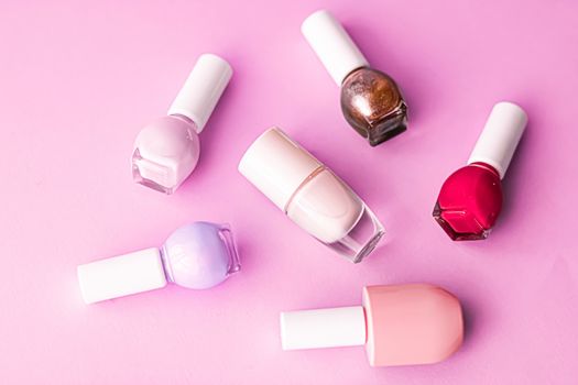 Nail polish bottles on pink background, beauty branding