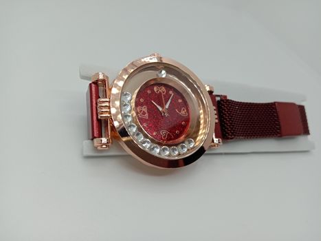 red colored watch closeup on gray background