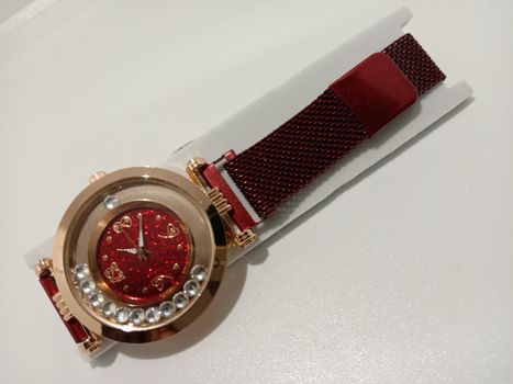 red colored watch closeup on gray background