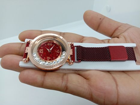 red colored watch closeup on gray background