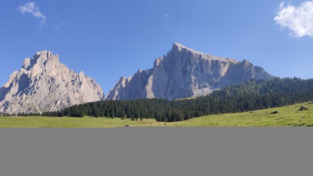 Val Gardena, Italy - 09/15/2020: Scenic alpine place with magical Dolomites mountains in background, amazing clouds and blue sky in Trentino Alto Adige region, Italy, Europe