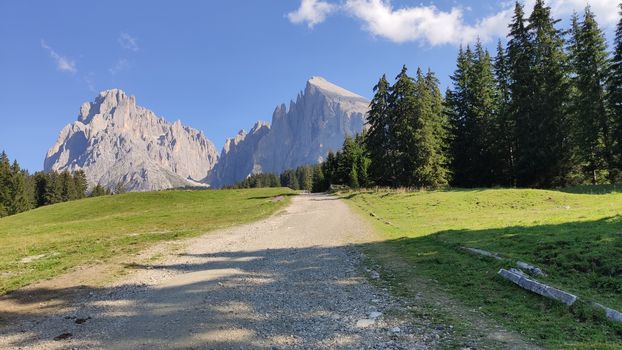 Val Gardena, Italy - 09/15/2020: Scenic alpine place with magical Dolomites mountains in background, amazing clouds and blue sky in Trentino Alto Adige region, Italy, Europe