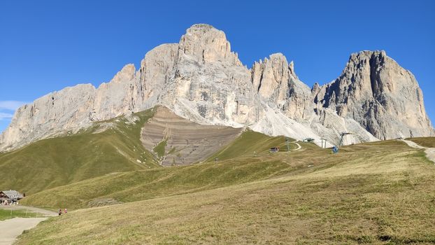 Val Gardena, Italy - 09/15/2020: Scenic alpine place with magical Dolomites mountains in background, amazing clouds and blue sky in Trentino Alto Adige region, Italy, Europe