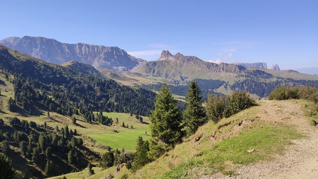 Val Gardena, Italy - 09/15/2020: Scenic alpine place with magical Dolomites mountains in background, amazing clouds and blue sky in Trentino Alto Adige region, Italy, Europe