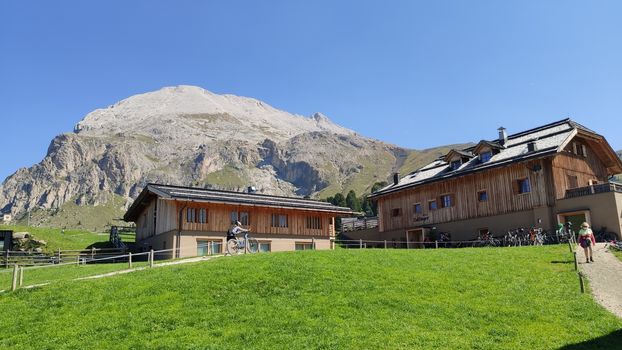 Val Gardena, Italy - 09/15/2020: Scenic alpine place with magical Dolomites mountains in background, amazing clouds and blue sky in Trentino Alto Adige region, Italy, Europe